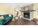 Comfortable living room showcasing a stone fireplace, hardwood floors, and a relaxing atmosphere at 6776 S Independence St, Littleton, CO 80128