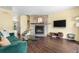 Cozy living room features stone fireplace, sleek flooring, and ample natural light at 6776 S Independence St, Littleton, CO 80128