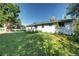 Exterior back view of the house with lawn and play set at 7704 Newland St, Arvada, CO 80003