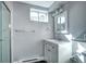 Bathroom with a vanity, toilet, shower and window for natural light at 7704 Newland St, Arvada, CO 80003