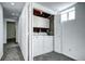 Laundry room with washer and dryer, cabinets, carpet flooring, and view to the hallway at 7704 Newland St, Arvada, CO 80003