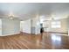 Spacious open-concept living area with hardwood floors, neutral paint, and kitchen access at 7704 Newland St, Arvada, CO 80003