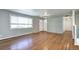 Bright living room with hardwood floors, large window, and neutral paint colors at 7704 Newland St, Arvada, CO 80003