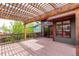 Inviting back deck with pergola and red railing offers a relaxing outdoor space and access to home at 5421 S Vivian St, Littleton, CO 80127