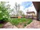 Landscaped backyard featuring a deck, shed, and greenery, perfect for outdoor enjoyment at 5421 S Vivian St, Littleton, CO 80127