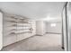 Unfinished basement with carpet, white walls, and shelving at 5421 S Vivian St, Littleton, CO 80127