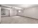 Unfinished basement showcasing neutral walls, carpet, storage shelving, and potential for a variety of uses at 5421 S Vivian St, Littleton, CO 80127