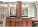 Bathroom featuring a dual sink vanity with granite countertops and a walk-in shower at 5421 S Vivian St, Littleton, CO 80127