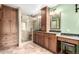 Full bathroom boasts dual sinks, granite countertops, and a large glass enclosed shower at 5421 S Vivian St, Littleton, CO 80127
