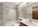 A full bathroom featuring tile walls and a tub and shower combination at 5421 S Vivian St, Littleton, CO 80127