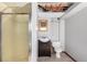A small bathroom features a stand up shower, and vanity and toilet. Needs some work at 5421 S Vivian St, Littleton, CO 80127