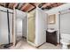 A bathroom features an enclosed shower and small toilet and vanity. Needs some work at 5421 S Vivian St, Littleton, CO 80127