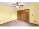 Bright bedroom with ceiling fan, closet, and yellow-painted walls at 5421 S Vivian St, Littleton, CO 80127
