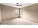 Bedroom with carpet flooring, ceiling fan, and large windows with natural lighting at 5421 S Vivian St, Littleton, CO 80127