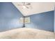 Spacious bedroom featuring neutral carpet and a large window at 5421 S Vivian St, Littleton, CO 80127