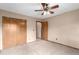 A bedroom with ceiling fan, carpet, and a closet with double wooden doors at 5421 S Vivian St, Littleton, CO 80127