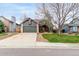 Charming home featuring a spacious front yard with mature trees and a two-car garage at 5421 S Vivian St, Littleton, CO 80127