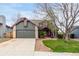 Charming home featuring a spacious front yard with mature trees and a two-car garage at 5421 S Vivian St, Littleton, CO 80127
