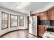 Bright kitchen eating space with stainless steel fridge and granite countertops at 5421 S Vivian St, Littleton, CO 80127