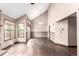 Open-concept living area with wood floors, vaulted ceilings, fireplace and access to the deck at 5421 S Vivian St, Littleton, CO 80127