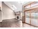 Bright living room featuring hardwood floors, fireplace and sliding glass doors to the deck at 5421 S Vivian St, Littleton, CO 80127