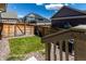 Cozy backyard space with a small grass patch, surrounded by decorative rocks and a wood fence at 17706 Cherokee St, Broomfield, CO 80023