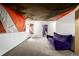 Finished basement with unique ceiling and purple sofa at 17706 Cherokee St, Broomfield, CO 80023