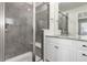 Modern bathroom featuring a glass-enclosed shower with gray tile and a white vanity with granite countertop at 17706 Cherokee St, Broomfield, CO 80023