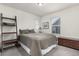 Comfortable bedroom with large windows, neutral decor, plush carpet, and ladder shelving at 17706 Cherokee St, Broomfield, CO 80023