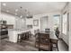 Open-concept kitchen and dining area with modern countertops, wood floors, and a stylish dining table at 17706 Cherokee St, Broomfield, CO 80023