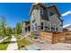 Beautiful home exterior with well-kept lawn, stone accents, and modern wood fencing, adding curb appeal at 17706 Cherokee St, Broomfield, CO 80023
