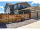 Home exterior showing backyard fence, rock landscaping, and a three-car attached garage at 17706 Cherokee St, Broomfield, CO 80023