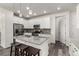 Modern kitchen with white cabinets, stainless steel appliances, and a center island with barstool seating at 17706 Cherokee St, Broomfield, CO 80023