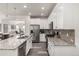 Modern kitchen with stainless steel appliances, granite countertops, and ample cabinet space at 17706 Cherokee St, Broomfield, CO 80023