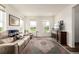 Cozy living room featuring a comfortable leather couch, and multiple windows at 17706 Cherokee St, Broomfield, CO 80023
