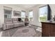 Bright living room with large windows, hardwood floors, and a comfortable seating area with a large rug at 17706 Cherokee St, Broomfield, CO 80023