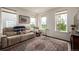 Bright living room with an area rug, and plentiful natural light from several windows at 17706 Cherokee St, Broomfield, CO 80023