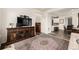Inviting living room featuring a decorative rug, TV, and an open floor plan with easy access to the kitchen at 17706 Cherokee St, Broomfield, CO 80023