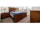 Comfortable main bedroom features a king-size bed and dark wood furniture with natural light from window at 17706 Cherokee St, Broomfield, CO 80023