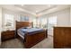 Spacious main bedroom with large windows, tray ceiling, and a beautiful wooden bed set at 17706 Cherokee St, Broomfield, CO 80023