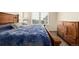 This main bedroom has ample natural light from the window and features a spacious layout and dark wood furniture at 17706 Cherokee St, Broomfield, CO 80023