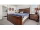 Spacious main bedroom with a wooden bed frame, two nightstands, and neutral-toned decor at 17706 Cherokee St, Broomfield, CO 80023