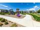 Community playground with colorful play structures and walking path, surrounded by well-maintained lawns at 17706 Cherokee St, Broomfield, CO 80023
