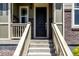 Close up of front porch with brick accents and steps leading to the main entry at 17706 Cherokee St, Broomfield, CO 80023