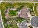 Aerial view of landscaped backyard with stone patio and mature trees at 22485 Laurel Oak Dr, Parker, CO 80138