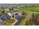 Aerial view of house with a circular driveway, mature trees, and corner lot at 22485 Laurel Oak Dr, Parker, CO 80138