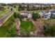Aerial view of property with mature trees, landscaping, and well-manicured lawn at 22485 Laurel Oak Dr, Parker, CO 80138