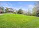 Spacious backyard with green grass, mature trees, and a fence line at 22485 Laurel Oak Dr, Parker, CO 80138