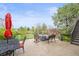 Grassy backyard with outdoor seating, mature trees, and shade for entertaining at 22485 Laurel Oak Dr, Parker, CO 80138