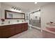 Bathroom with double vanity, a large mirror, and a glass-enclosed shower with tiled walls at 22485 Laurel Oak Dr, Parker, CO 80138
